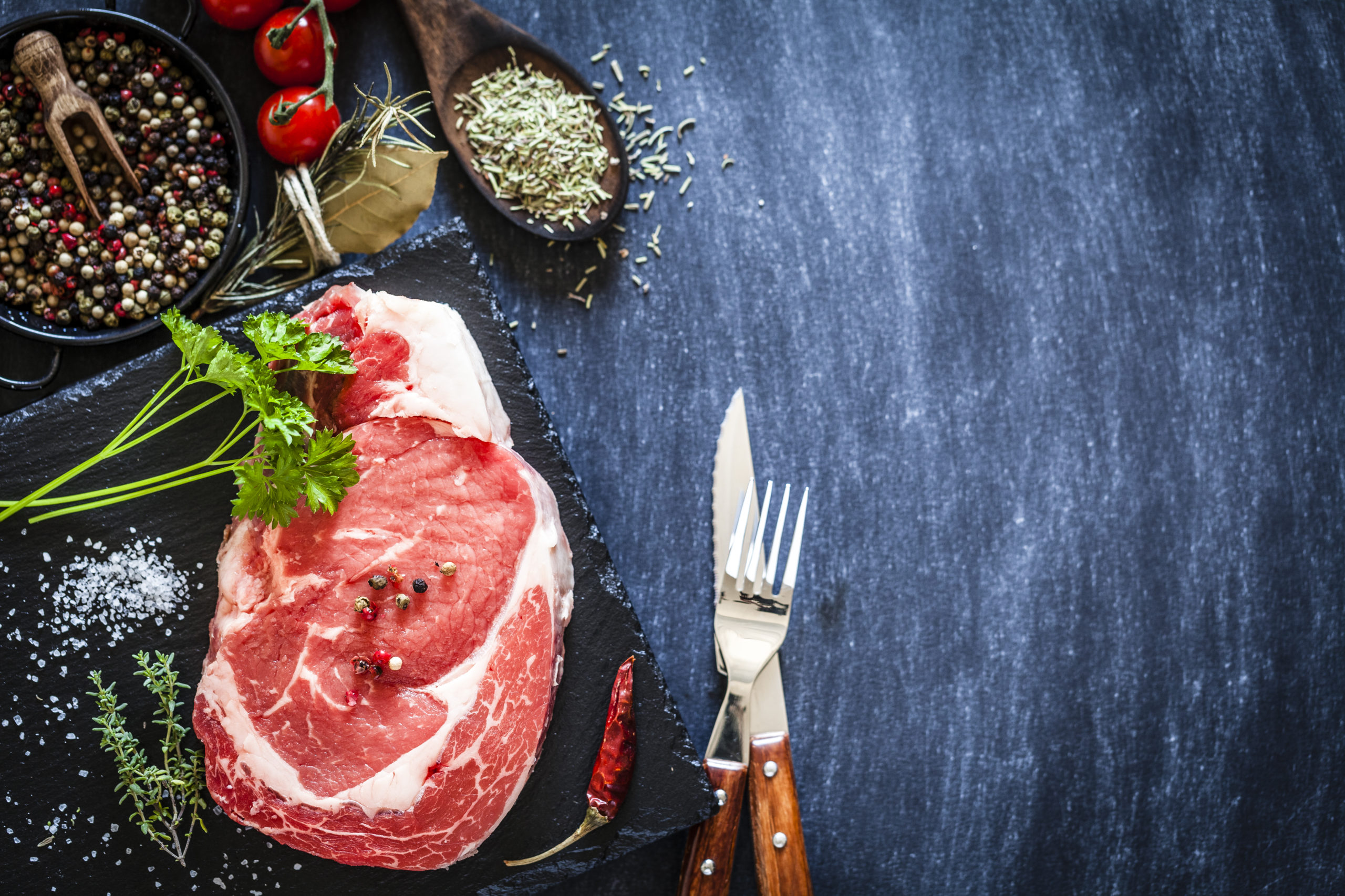 Fresh raw beef steak on dark background